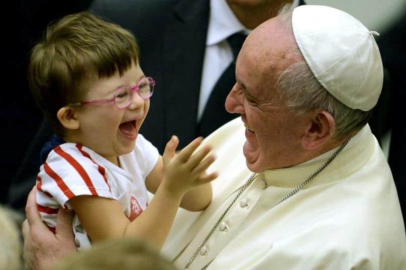 Pope Francis and a little girl enjoying one another's company.
