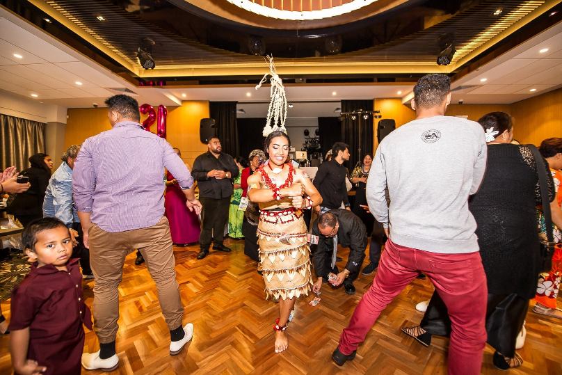 Seselia Taufa'ao performs the Tau'olunga at her 21st birthday, with the guests, as is custom, showing their appreciation by attaching gifts of money to her dress.