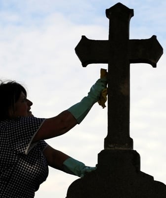 A woman cleans a tombstone at a cemetery in Oviedo, Spain, on 31 October, the eve of All Saints' Day. People mark the special day by visiting the graves of deceased relatives and friends. Photo: CNS/Eloy Alonso, Reuters