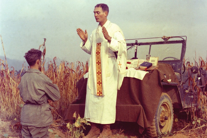 U.S. Army chaplain Father Emil Joseph Kapaun, who died May 23, 1951, in a North Korean prisoner of war camp, is pictured celebrating Mass from the hood of a jeep on 7 October, 1950, in South Korea. He was captured about a month later. Photo: CNS/courtesy U.S. Army medic Raymond Skeehan 