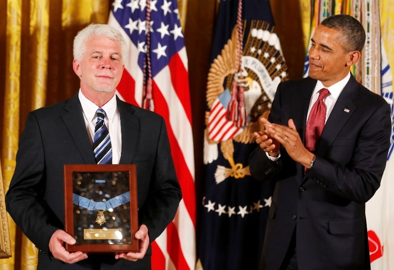 U.S. President Barack Obama presents the Medal of Honour to Ray Kapaun, who accepted it on behalf of his uncle, U.S. Army chaplain Fr Emil Joseph Kapaun, at the White House in Washington on 11 April, 2013. The priest was honored with the nation's highest military award for bravery. Photo: CNS/Larry Downing, Reuters