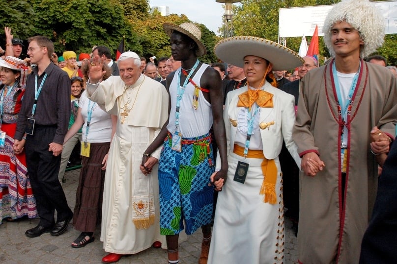 Pope Benedict XVI walks hand-in-hand with young people during World Youth Day in Cologne, Germany, in 2005. Photo: CNS 