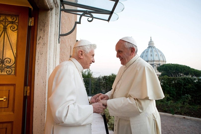 Cardinal Joseph Ratzinger, who became Pope Benedict XVI (pictured with Pope Francis in 2013), said there was no theological basis for national episcopal conferences. The synod is currently discussing whether national conferences should be able to adopt pastoral practices regarding the family that are radically different from preceding practices. Photo: CNS/L'Osservatore Romano via Reuters.