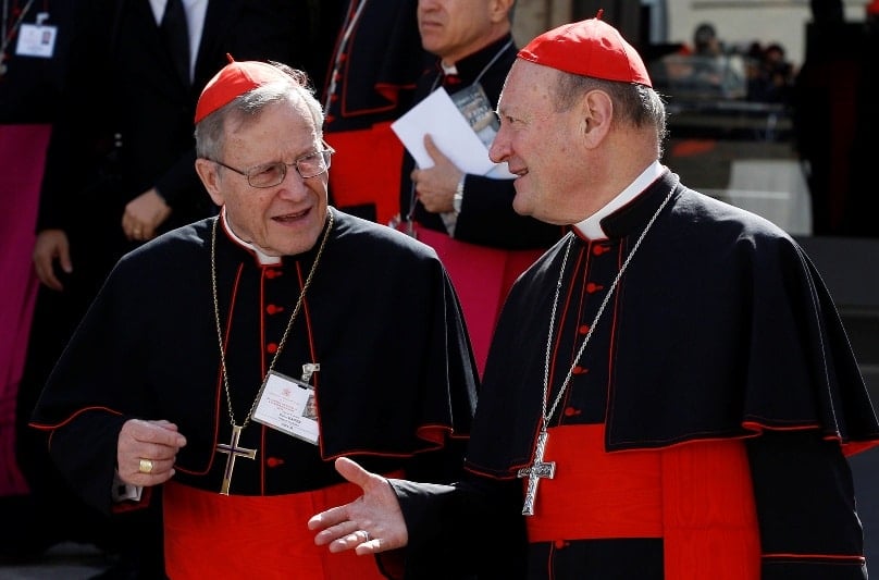 German Cardinal Walter Kasper, retired president of the Pontifical Council for Promoting Christian Unity, talks with Cardinal Gianfranco Ravasi, president of the Pontifical Council for Culture, as they leave the morning session of the extraordinary Synod of Bishops on the family at the Vatican in October 2014. Photo: CNS/Paul Haring