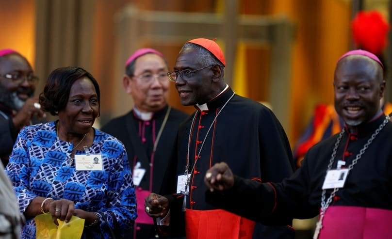 Cardinal Robert Sarah, centre, leaves the concluding session of the extraordinary Synod of Bishops on the family at the Vatican in October 2014. Photo: CNS/Paul Haring