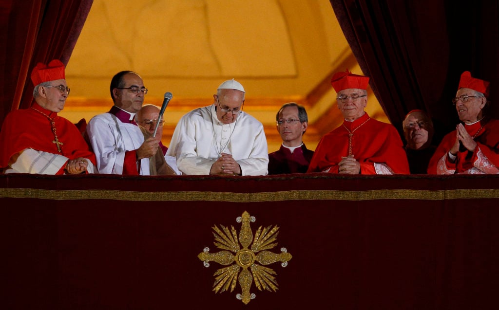 Pope Francis bows his head in prayer during his election night appearance on the central balcony of St Peter's Basilica on 13 March, 2013. Photo: CNS/Paul Haring