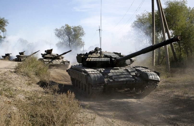 Soldiers of the self-proclaimed Luhansk People's Republic movement ride tanks as they withdraw from the front line outside Luhansk, Ukraine, on 3 October. Photo: CNS/Alexander Ermochenko, Reuters