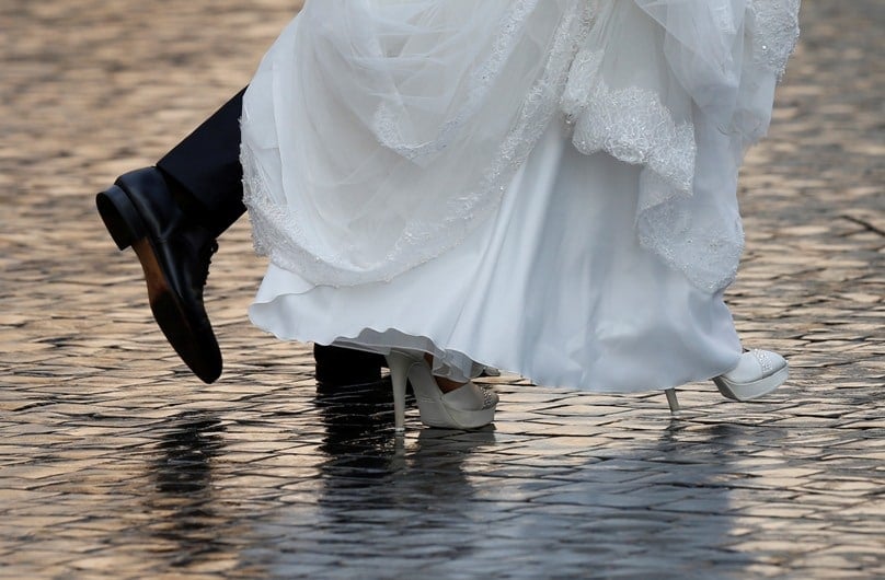 A newly married couple arrive in St. Peter’s Square to attend Pope Francis’ general audience at the Vatican on 14 October. Photo: Paul Haring, CNS