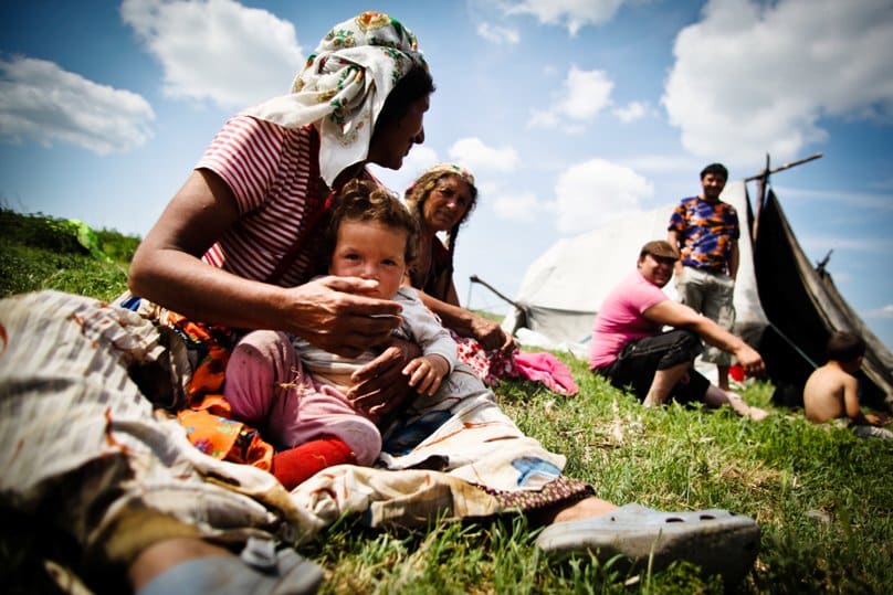 In this May 2012 file photo, a Roma family in a Gypsy camp rests in Valea Stanii, Romania. Photo: CNS/Mihai Barbu, EPA