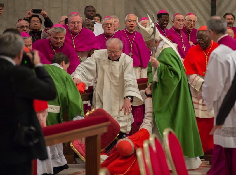 French Cardinal Roger Etchegaray, 93, falls as he greets Pope Francis as the pope leaves the concluding Mass of the Synod of Bishops on the family in St Peter's Basilica at the Vatican on 25 October. Photo: CNS 