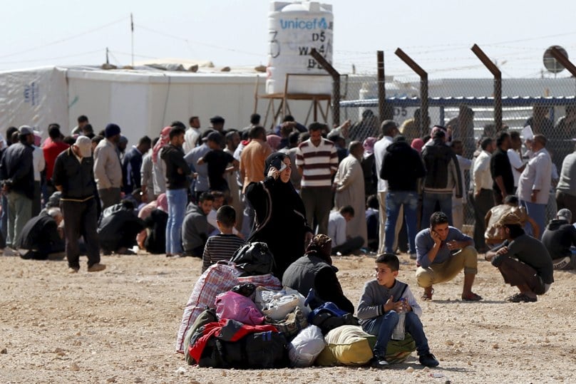 Syrians refugees at the Zaatari refugee camp on 1 November wait to register their names to return to their homeland in Syria. The U.N. refugee agency reports that currently about 100 Syrians return home nearly every day from Jordan. Photo: CNS/Muhammad Hamed, Reuters 