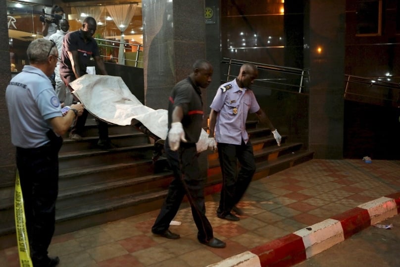 Officials carry a body outside the Radisson Hotel in Bamako, Mali, on 20 November. At least 22 people were killed that day when gunmen raided the hotel and held 170 people hostage. Photo: CNS/Joe Penney, Reuters