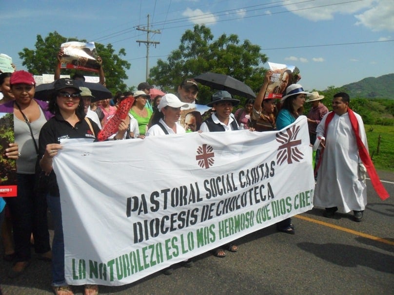 Fr Bernardino Lazo, far right, joins a protest in May 2014 with Caritas Choluteca in Jicaro Galan, department of Valle, Honduras. The sign sayd "nature is the most beautiful creation by God". Photo: CNS/Mary Duran