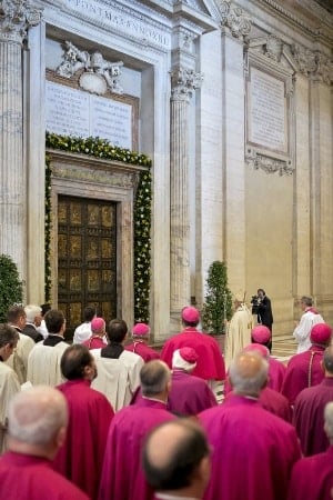 Pope Francis stands in front of the Holy Door in early April prior to first vespers of Divine Mercy Sunday in St Peter's Basilica at the Vatican. Photo: CNS/Andrea Solaro, Reuters pool