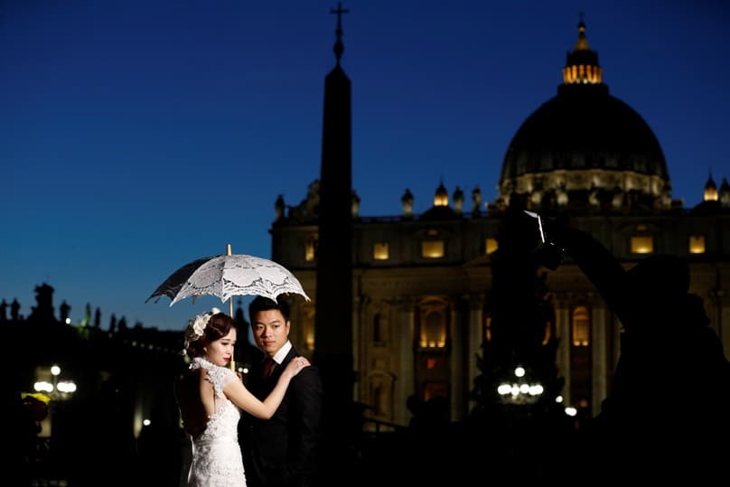 A newly married couple from China pose for photos in front of St Peter’s Basilica at the Vatican last year. In another decade, more than 30 million Chinese men will have no prospect of marrying thanks to population control. Photo: CNS