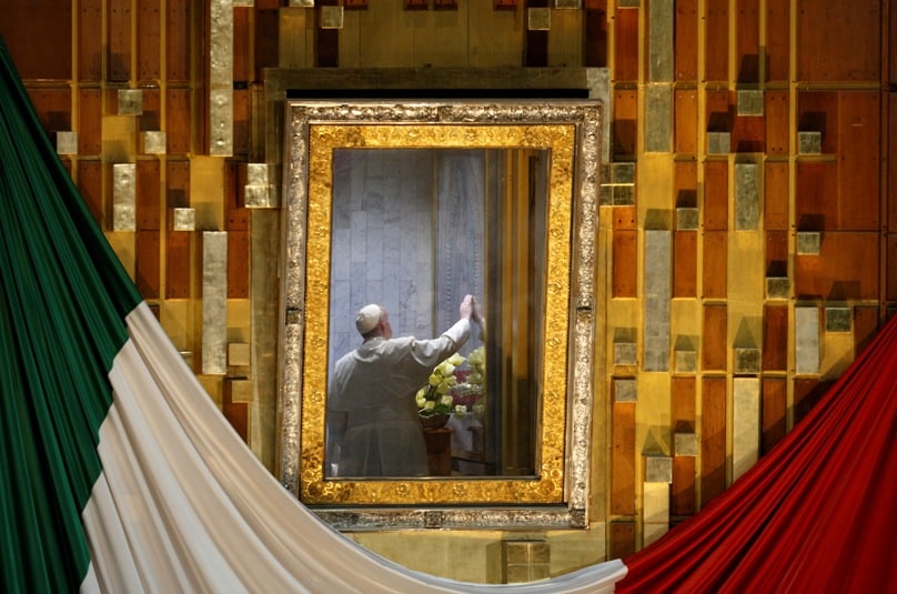 Pope Francis touches the original image of Our Lady of Guadalupe after celebrating Mass in the Basilica of Our Lady of Guadalupe in Mexico City on 13 February. The Marian image was rotated for the pope to pray in the "camarin" ("little room") behind the main altar. Photo:  CNS/Paul Haring