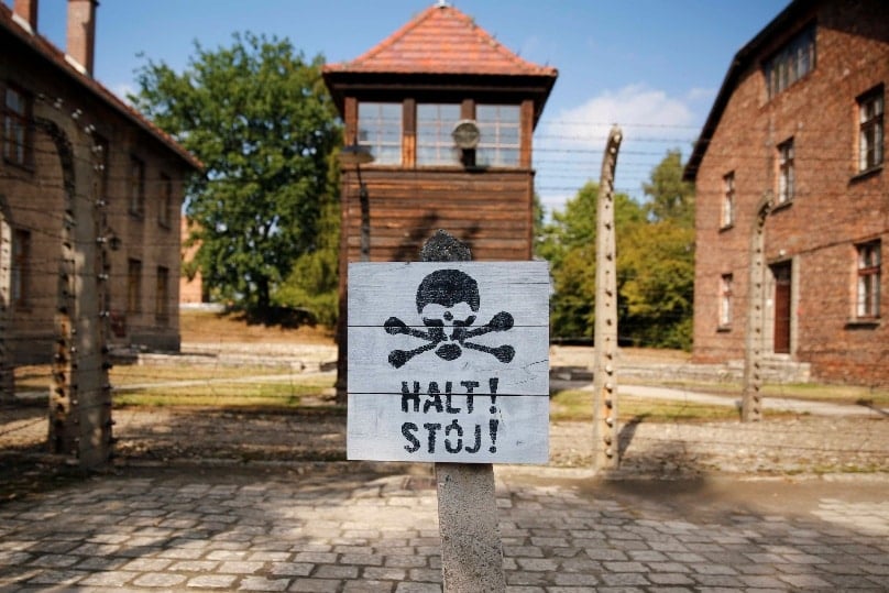 A guard tower is seen beyond an area enclosed with barbed wire at the Auschwitz-Birkenau Memorial and State Museum in Oswiecim, Poland. Photo: CNS/Nancy Wiechec