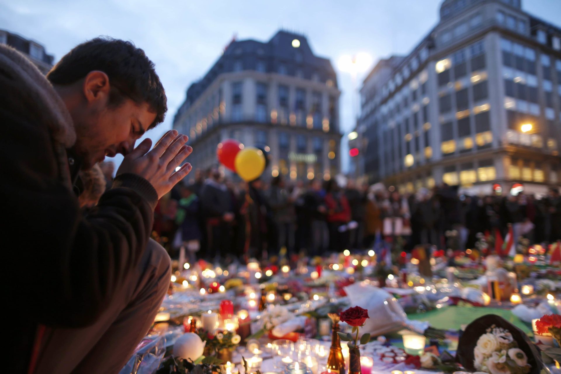 A man prays during a March 23 memorial gathering in Brussels following bomb attacks the previous day. Three nearly simultaneous attacks claimed the lives of dozens and injured more than 200. (CNS photo/Christian Hartmann, Reuters) See BRUSSELS-AIRPORT-CHAPLAIN March 24, 2016.