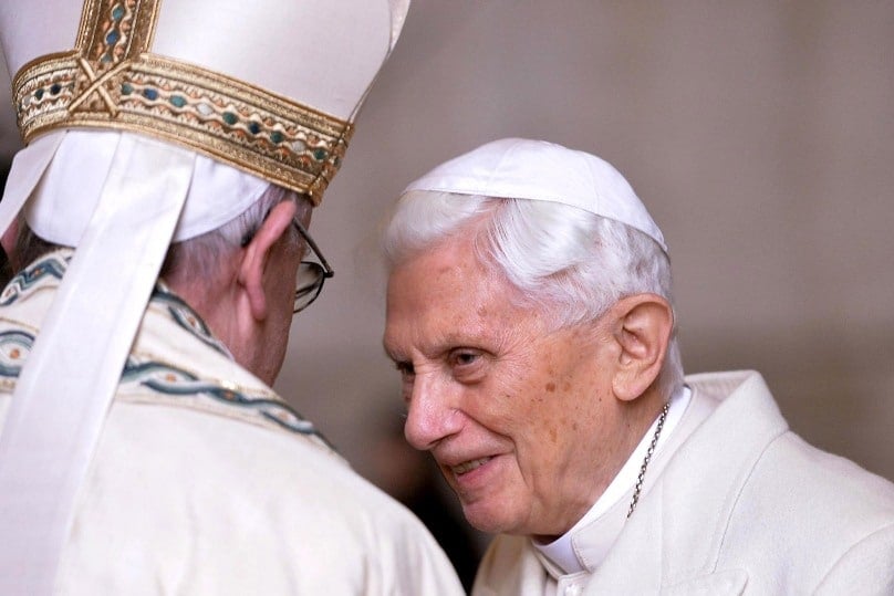 Pope Francis greets retired Pope Benedict XVI prior to the opening of the Holy Door of St Peter's Basilica at the Vatican in 2015. Photos: CNS/Maurizio Brambatti, EPA
