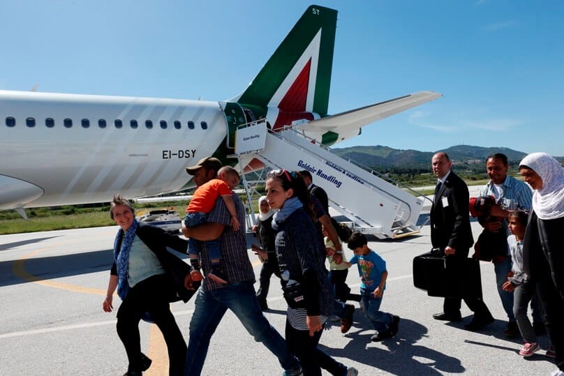 Refugees walk to board Pope Francis' plane to Rome at the international airport in Mytilene on the island of Lesbos, Greece. Photo: CNS/Paul Haring