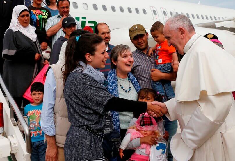 Pope Francis greets Syrian refugees he took to Rome from the Greek island of Lesbos, at Ciampino airport in Rome on 16 April. The pope concluded his one-day visit to Greece by taking 12 Syrian refugees to Italy aboard his flight. Photo: Paul Haring/CNS