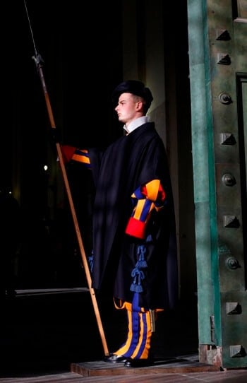 A Swiss Guard stands at the entrance to the Apostolic Palace at the Vatican. Photo: CNS/Paul Haring
