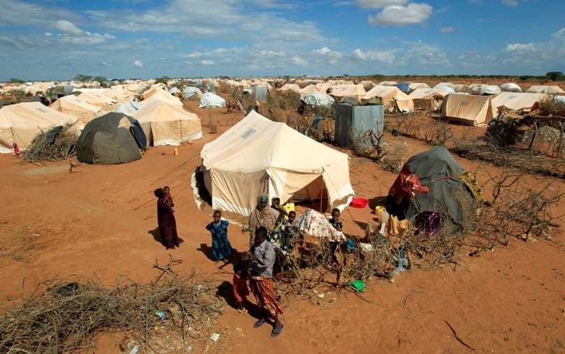 Refugees stand outside their tent in 2011 at the Ifo Extension refugee camp in Dadaab, Kenya, across the border from Somalia. Photo: CNS/Thomas Mukoya, Reuters