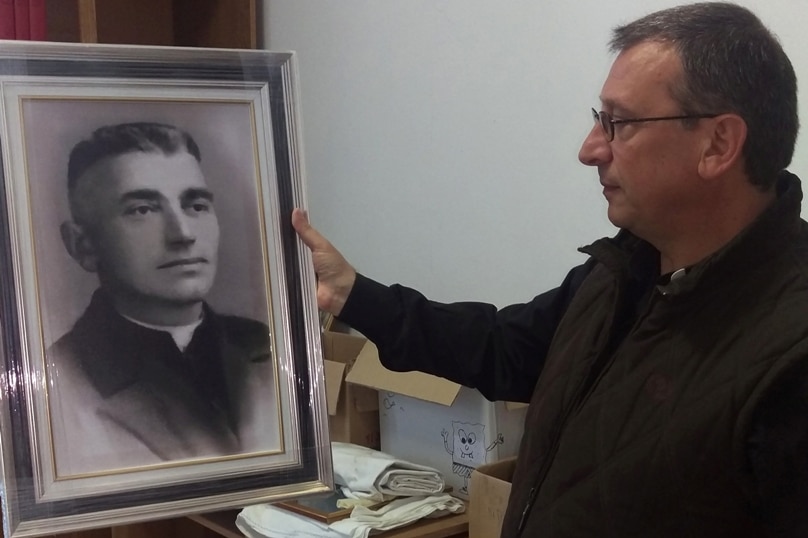 Franciscan Br Vincenzo Foca holds a photo of Fr Luigj Prendushi in Shkoder, Albania. Photo: CNS/James Martone