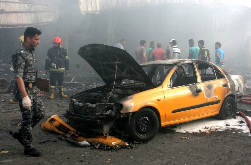 An Iraqi policeman inspects the site of a suicide bomb attack in Baghdad, on 25 April. Photo: CNS/Ahmed Ali, EPA