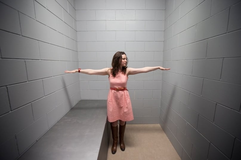 Rev Laura Markle Downton, director of the U.S. Prisons Policy and Program at the National Religious Campaign Against Torture, is pictured in a replica solitary confinement cell during the Ecumenical Advocacy Days event in 2015. Photo: CNS/Erin Schaff, courtesy Perisphere Media