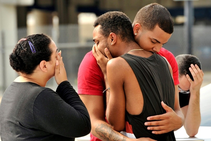 People embrace outside the headquarters of the Orlando, Florida, Police Department on 12 June during the investigation of a mass shooting at a gay nightclub in Orlando. Photo: CNS/Steve Nesius, Reuters