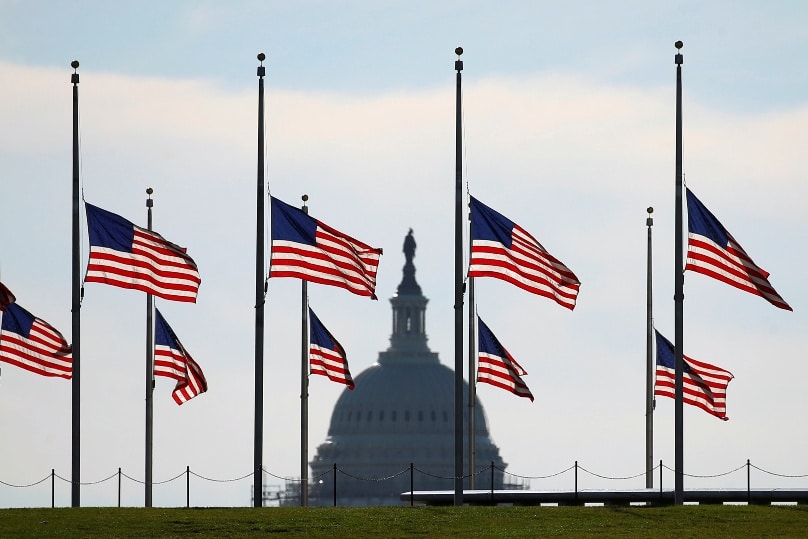 Flags at the Washington Monument fly at half staff on 13 June to honour those killed in a 12 June mass shooting at a gay nightclub in Orlando, Florida. Photo: CNS/Kevin Lamarque, Reuters
