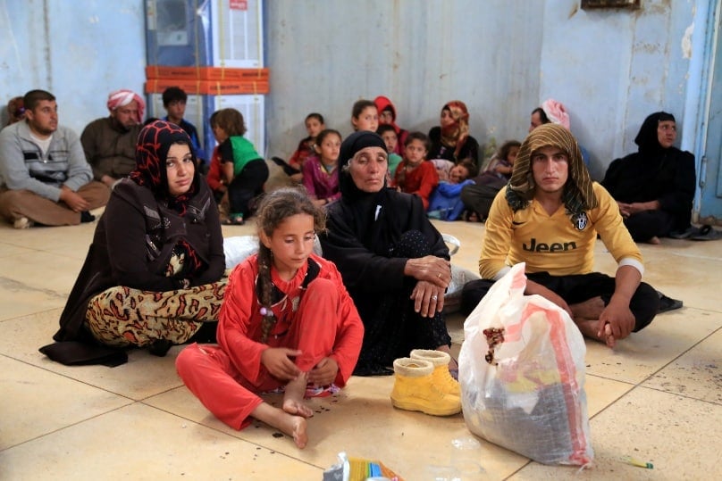 Displaced families await temporary shelter in Kirkuk, Iraq, on 11 June. Catholic and Orthodox patriarchs called for the rapid liberation of areas under control of the Islamic State group to end ethnic and religious genocide. Photo: CNS/Stringer, EPA