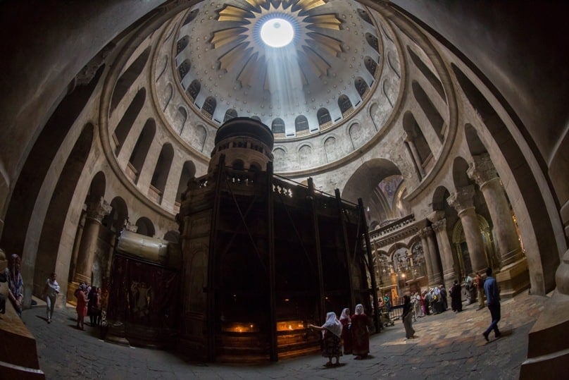 Tourists and Christian pilgrims visit the tomb where it is believed Christ was buried inside the Church of the Holy Sepulchre in Jerusalem on 17 Apri. For the first time in 200 years, experts have begun a restoration of the Edicule of the Tomb. Photo: CNS/Jim Hollander, EPA
