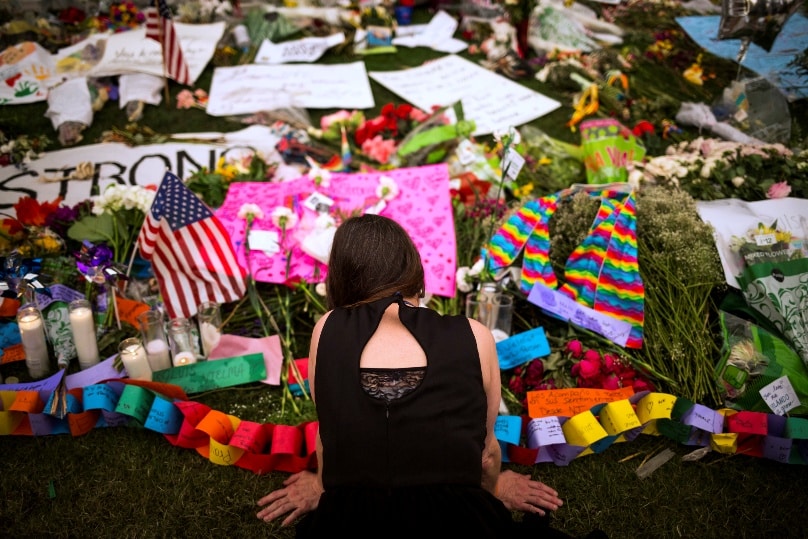 A woman visits a memorial in downtown Orlando, Florida, on 14 June, that honors the victims of the mass shooting at a gay nightclub. Photo: CNS/John Taggart, EPA