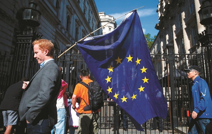 A man carries a European Union flag in London on 24 June, a day after voters in the United Kingdom decided to leave the EU. Photo: Neil Hall, Reuters