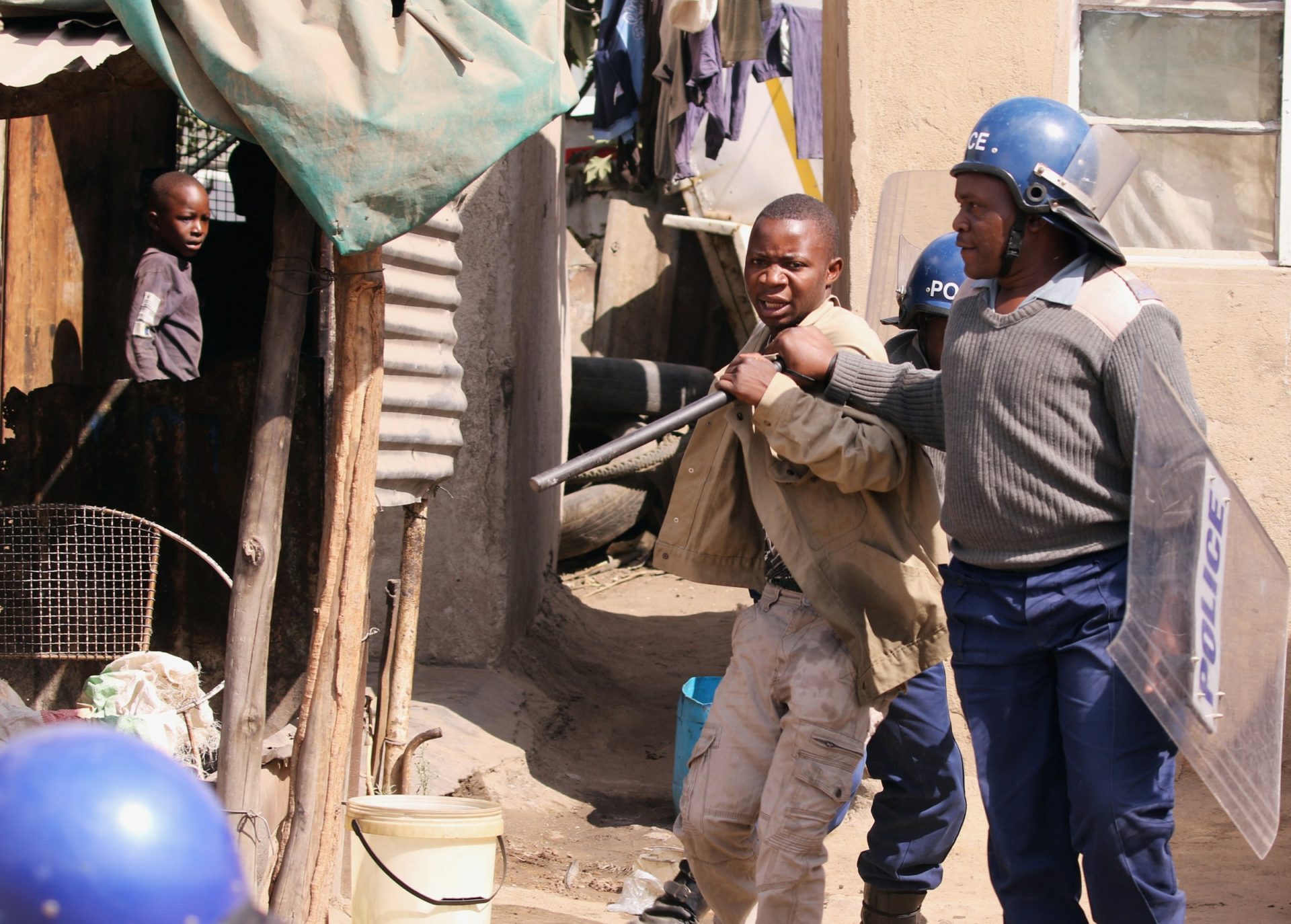 Riot police detain residents after a protest by taxi drivers turned violent on 4 July in Harare, Zimbabwe. The nation's church leaders called on the government to listen to the cries of its suffering citizens, warning that their grievances could soon explode into civil unrest if not addressed. Photo: CNS/Philimon Bulawayo, Reuters