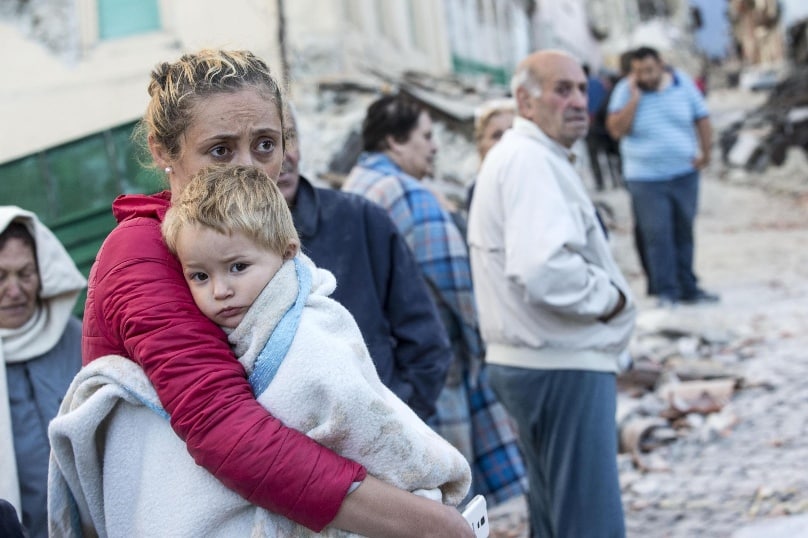 A mother embraces her son in Amatrice, Italy, following an earthquake on 24 August. Photo: CNS/Massimo Percossi, EPA