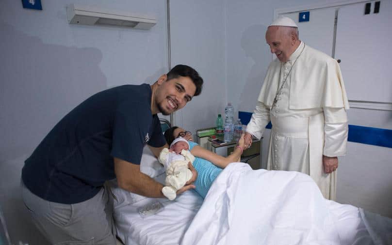 Pope Francis greets a mother as he visits the neonatal unit at San Giovanni Hospital in Rome. Photo: CNS/L'Osservatore Romano