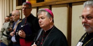 Archbishop Anthony Fisher OP prays at Youth Synod