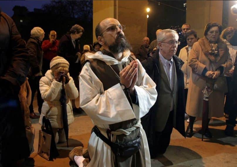 A religious prays at a demonstration against the exhibit outside Pamplona's town hall on Monday night.