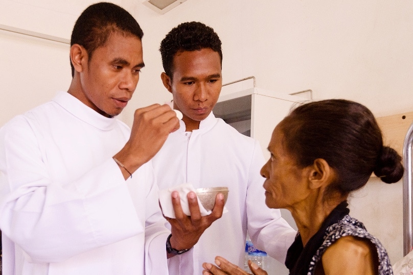 Zaccarias (centre) assists with the ministry of Communion at the local hospital in Dili, Timor-Leste.