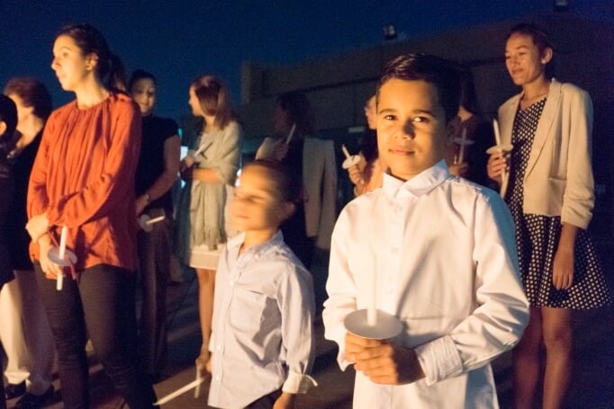 Children and young adults wait to light candles from the Paschal Candle during the Easter Vigil liturgy conducted by the first and second communities of the Neocatechumenal Way at Baulkham Hills. Photo: Peter Rosengren