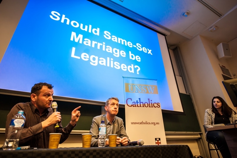 Former gay rights activist James Parker speaks at a debate on same-sex marriage at the University of NSW last Wednesday evening, as his interlocutor, Marriage Equality CEO Tiernan Brady, and moderator Monica Doumit look on. Photo: Giovanni Portelli