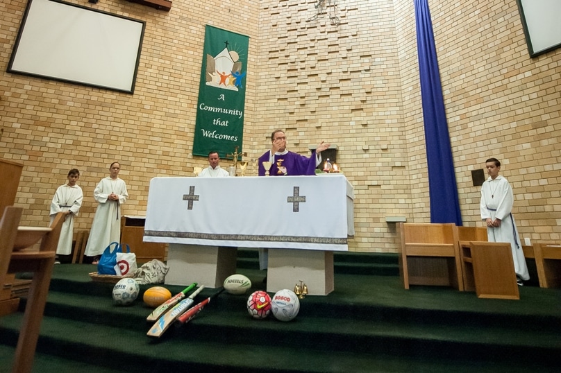 Fr Mick Court SDB celebrates the annual Sports Mass at St John Bosco, Engadine. Photo: Giovanni Portelli