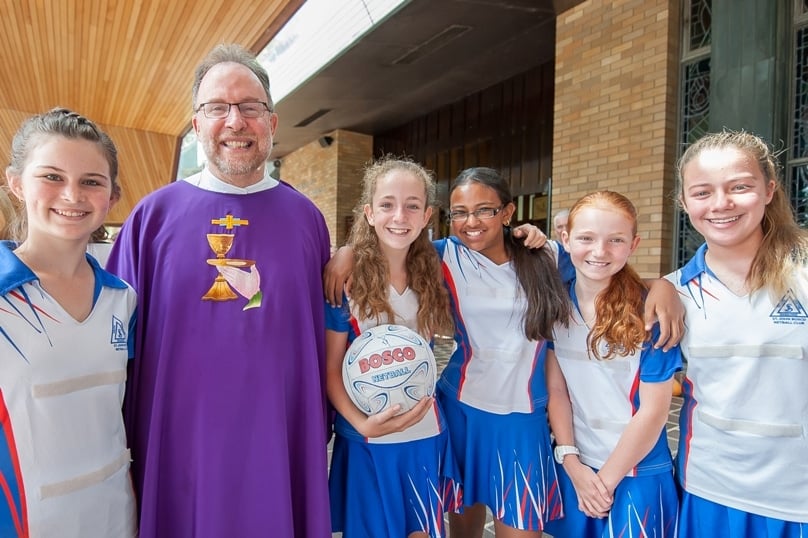 Fr Mick Court pictured with parishioners at the annual Sports Mass at St John Bosco, Engadine. Photo: Giovanni Portelli