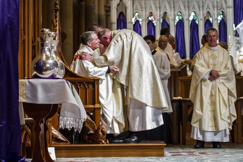 Archbishop Anthony Fisher OP is greeted by Bishop Terry Brady at the Chrism Mass at St Mary's Cathedral on 24 March. Photo: Giovanni Portelli