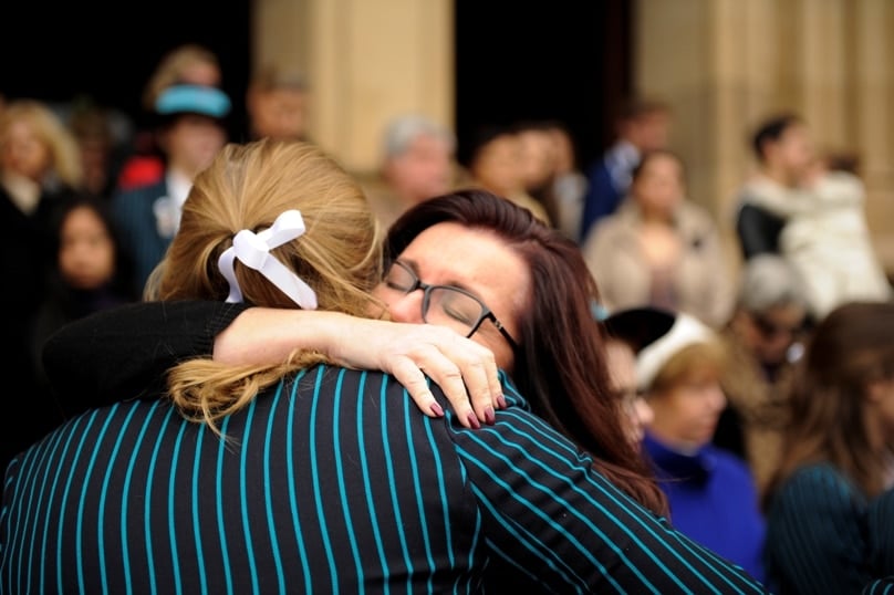 Students embrace after  Mass at St Mary's Cathedral to honour those lost in the MH17 airliner tragedy. Photo: Giovanni Portelli