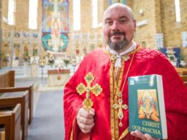 Fr Simon Ckuj pictured with a copy of Christ Our Pascha will be launched in Sydney on 5 October. Photo: Giovanni Portelli
