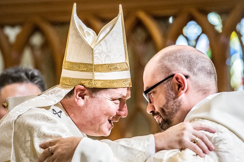 Fr Josh Miechels is embraced by Archbishop Anthony Fisher OP minutes after the archbishop ordained Deacon Miechels to the priesthood. Photo: Giovanni Portelli